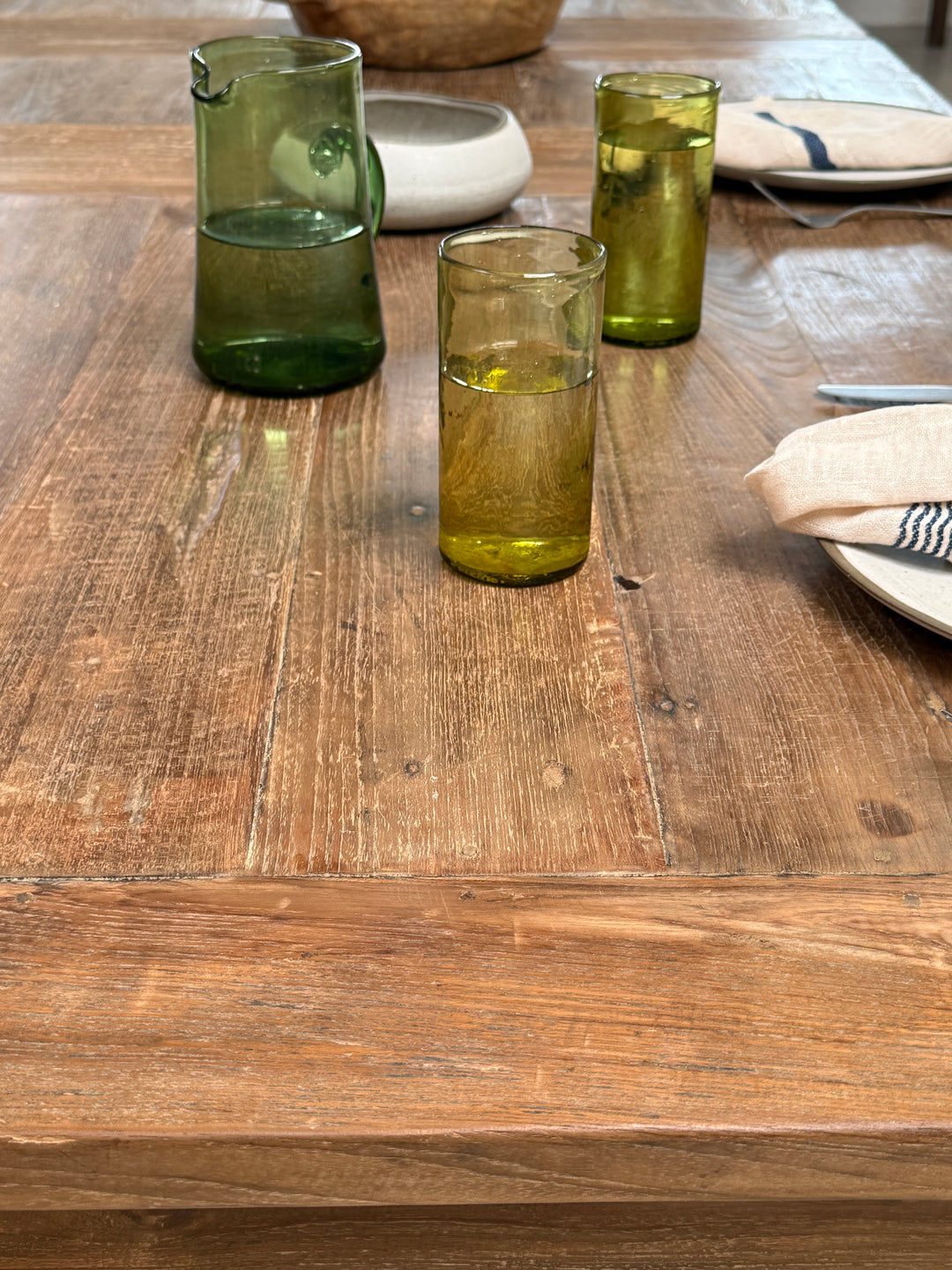 Close-up of the rustic teak dining table celebrating the unique markings, rich colour variation and handcrafted finish that make reclaimed teak so distinctive.
