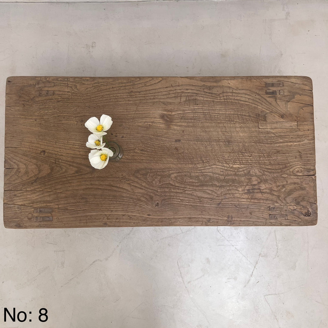 Wooden cutting board with flowers on a light gray surface