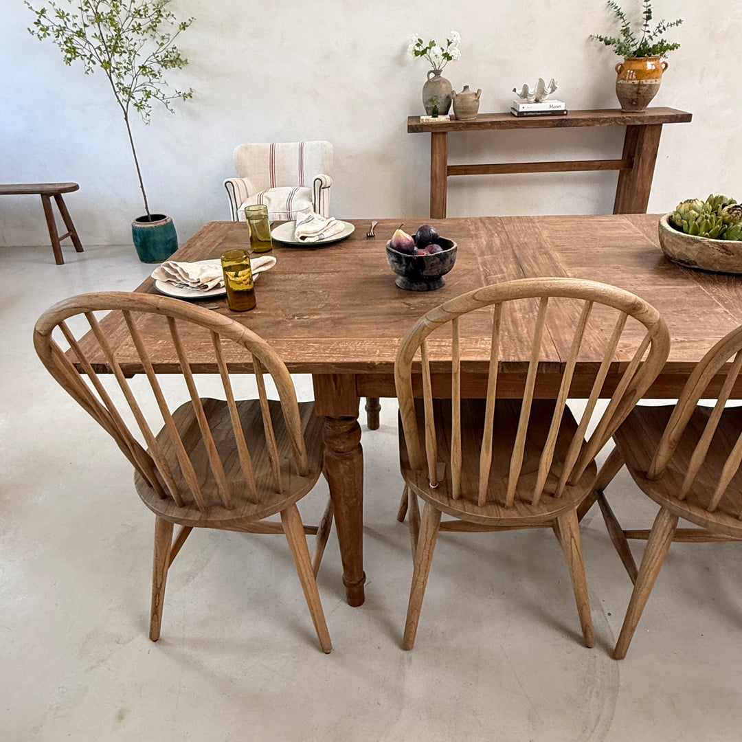 Detailed view of the salvaged teak dining table revealing the distinctive grain, weathered texture and authentic character developed through years of use.