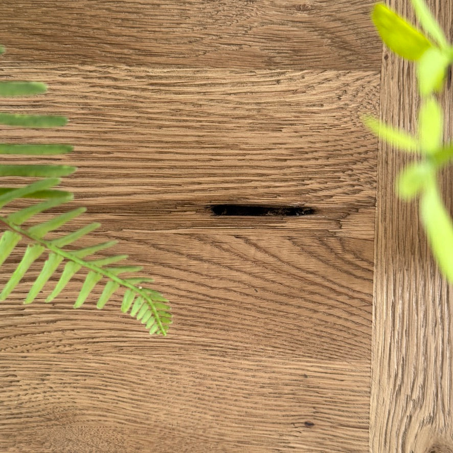 Characterful reclaimed oak tabletop with natural historic markings on the Suffolk dining table