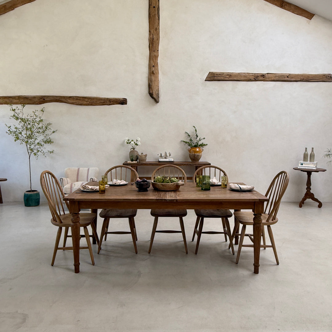 The sustainable teak dining table styled with handcrafted tableware and natural textures, bringing warmth, craftsmanship and enduring quality to a contemporary dining room.