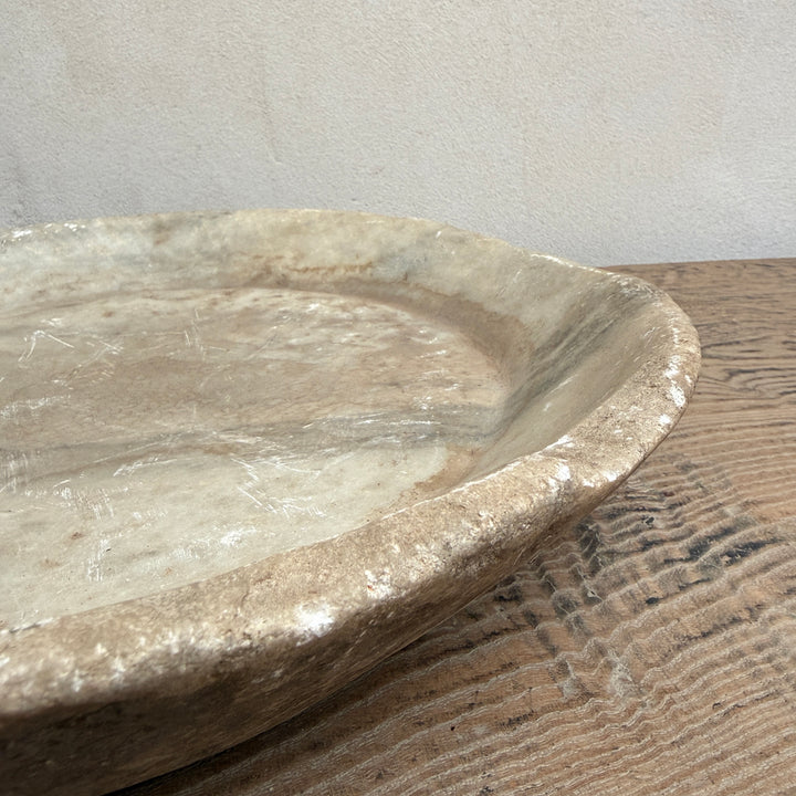 Close-up of a vintage Indian marble bowl showing weathered stone texture, natural markings and handcrafted character.