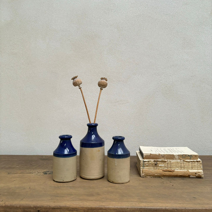 Set of three blue rim earthenware antique bottles