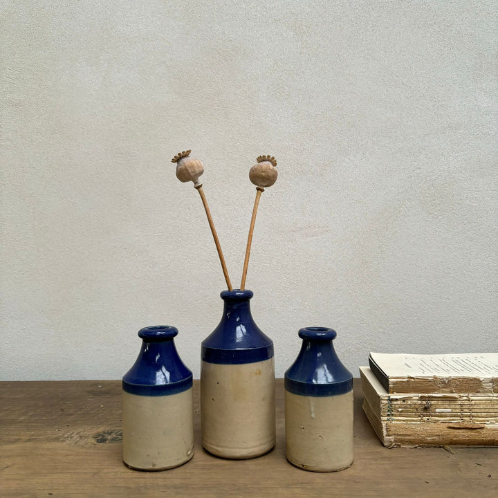 Set of three blue rim earthenware antique bottles