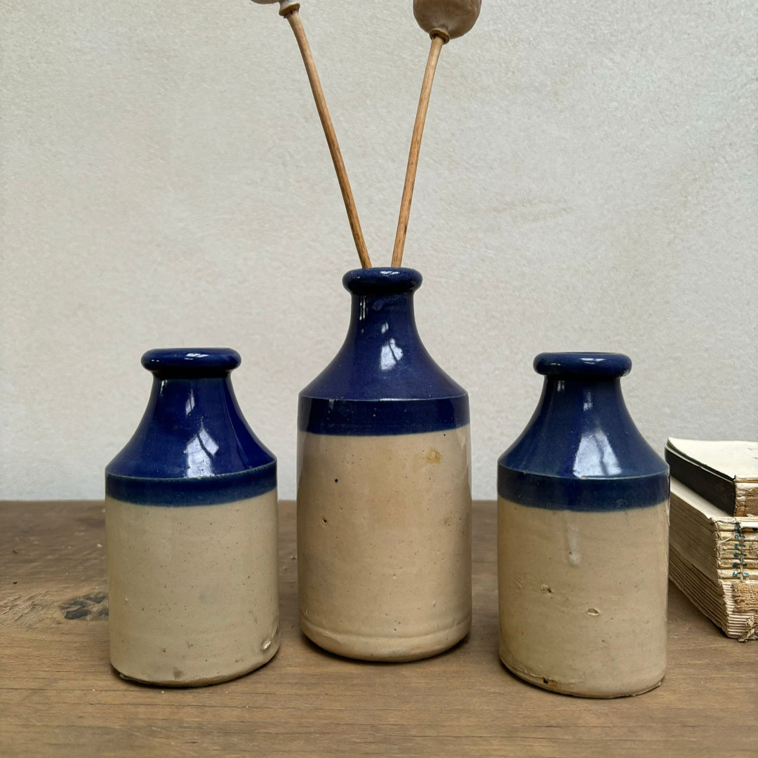 Set of three blue rim earthenware antique bottles