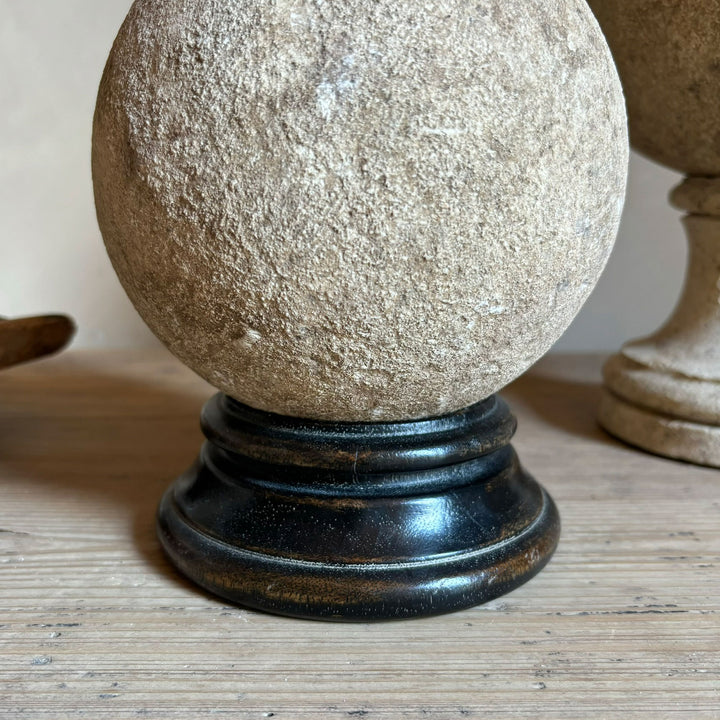 Wooden stand for aged stone sphere