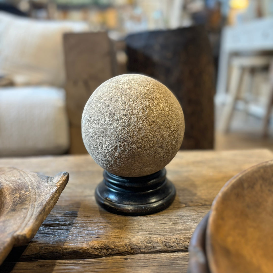 Wooden stand for aged stone sphere