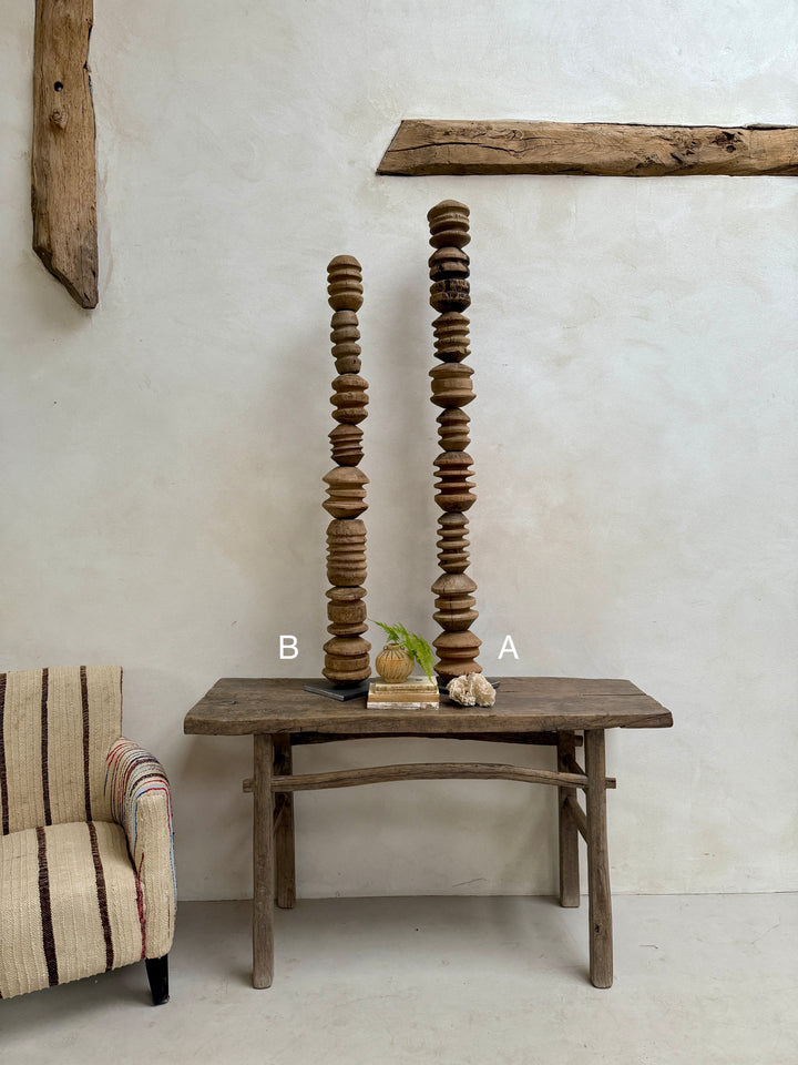 Wooden totem pole of pulleys