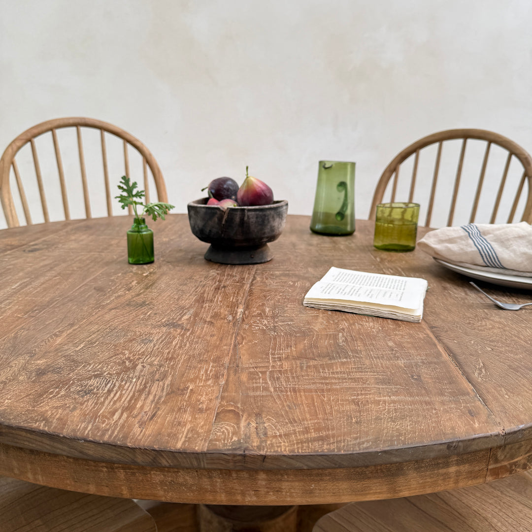 Close-up of the York reclaimed teak round dining table highlighting the rich grain, natural colour variation and historic markings of solid salvaged teak.