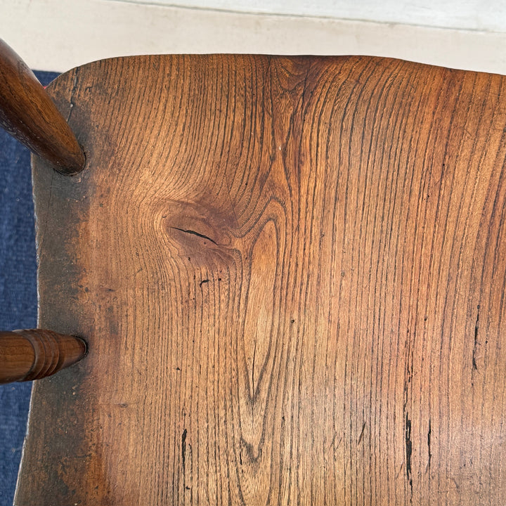 Close-up of the beautifully aged solid elm seat with rich natural grain and historic patina.
