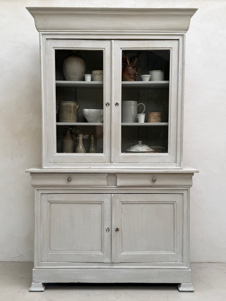 Front view of the antique French painted oak Buffet Deux Corps cabinet with glazed doors closed.
