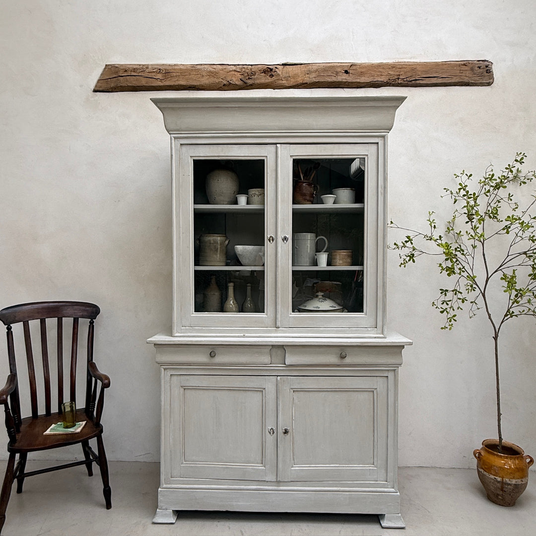 Antique French painted oak Buffet Deux Corps styled with decorative accessories in a luxury country interior.
