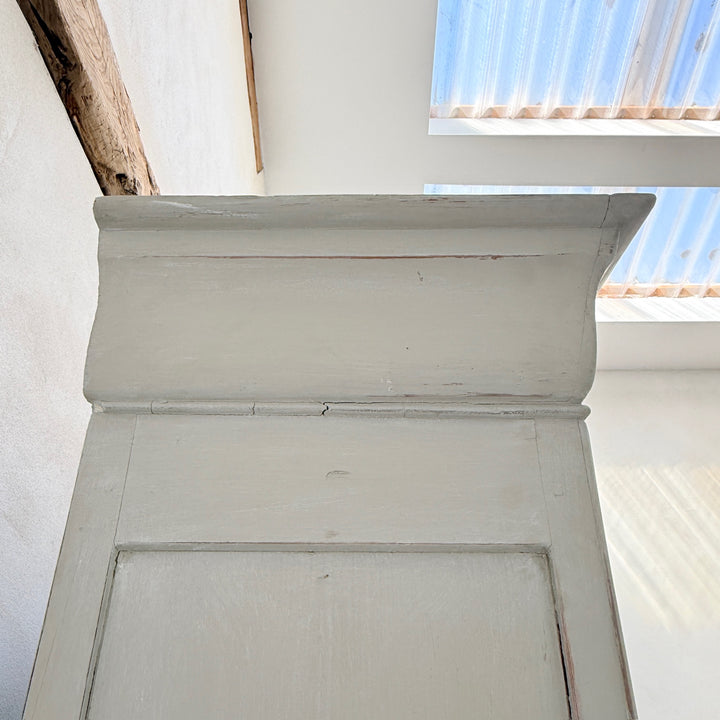 Decorative cornice detail on the antique French painted oak Buffet Deux Corps.
