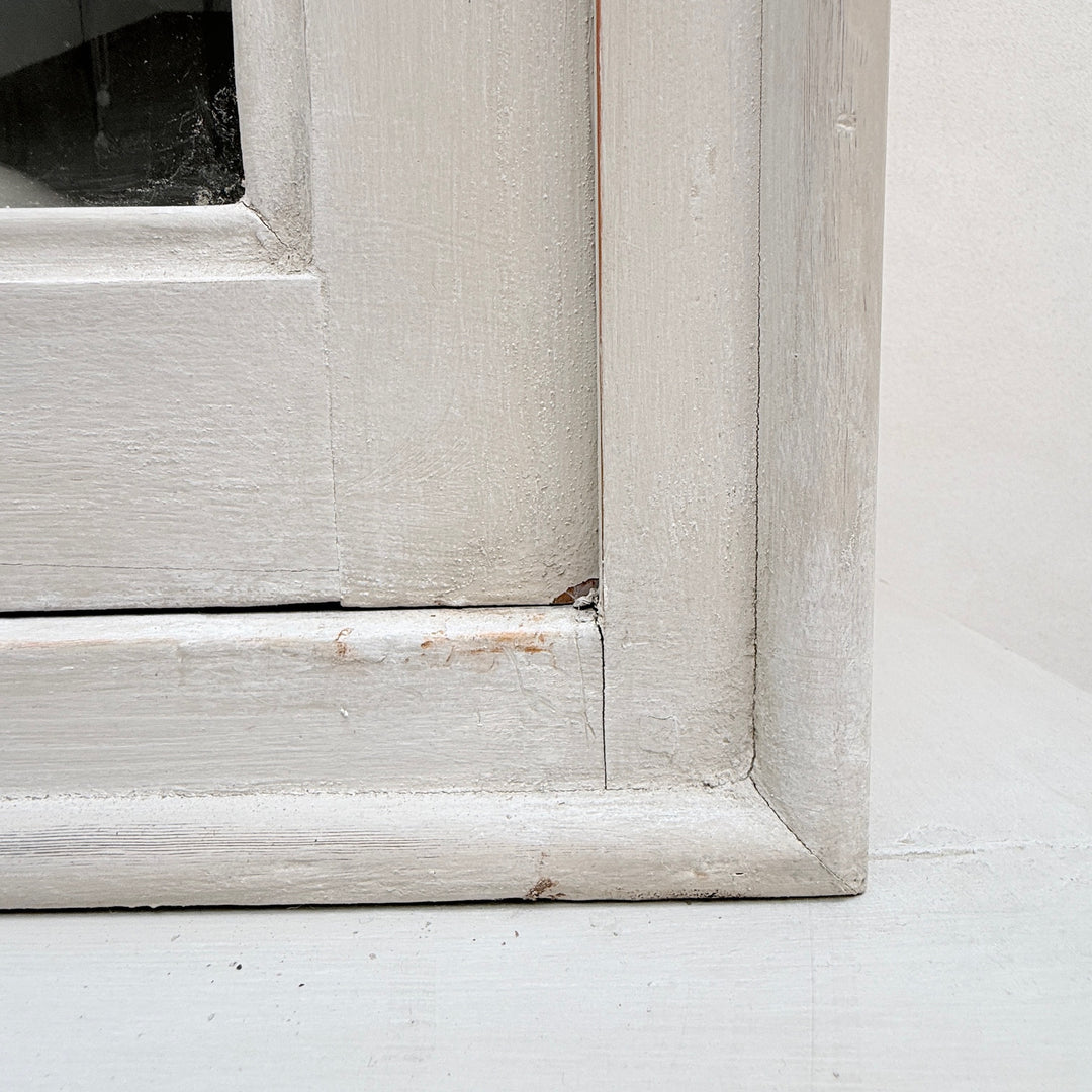 Close-up of the traditional framed door construction on the antique French cabinet.
