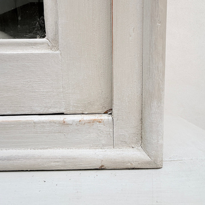 Close-up of the traditional framed door construction on the antique French cabinet.
