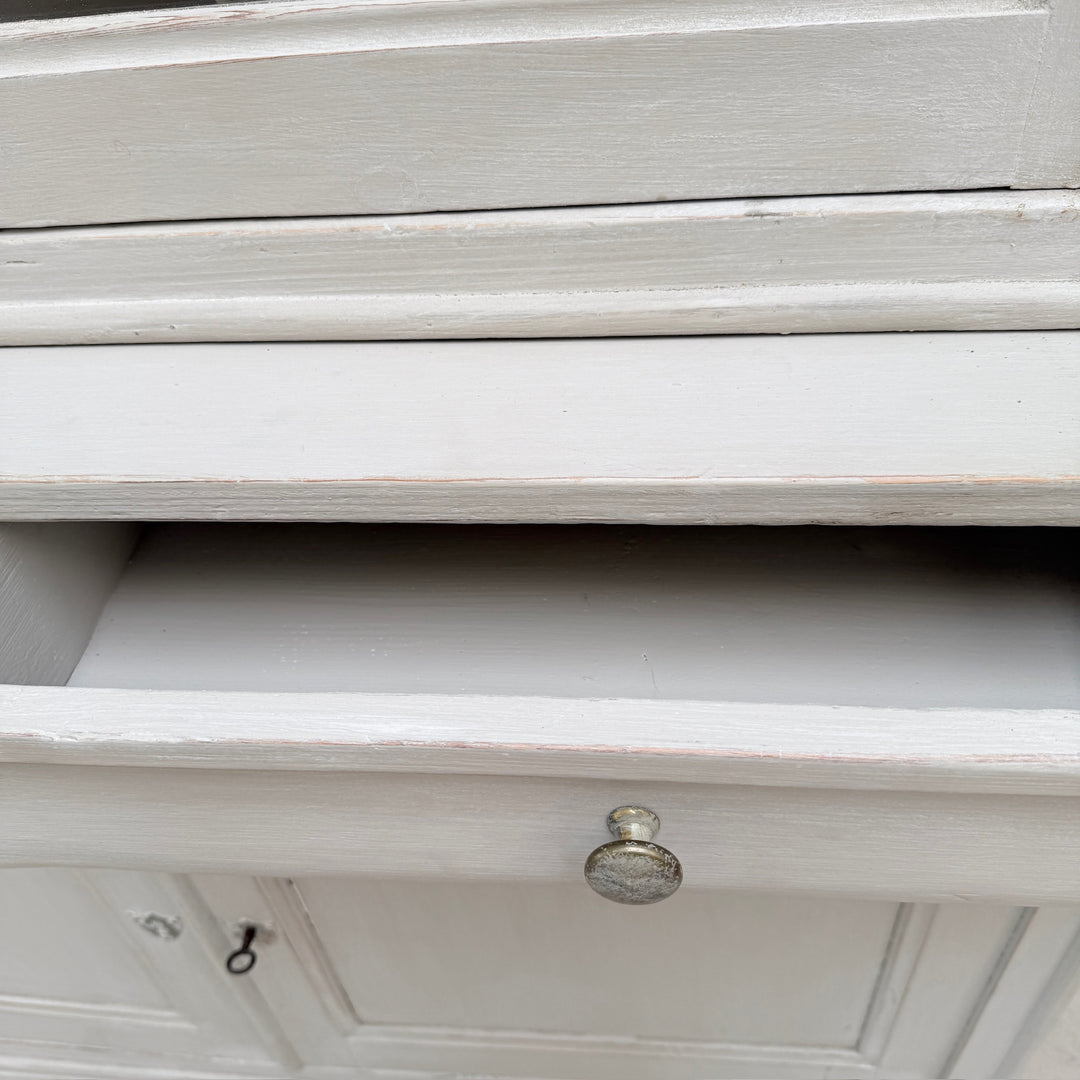 A close up of the inside of a drawer on the antique French painted oak Buffet Deux Corps.
