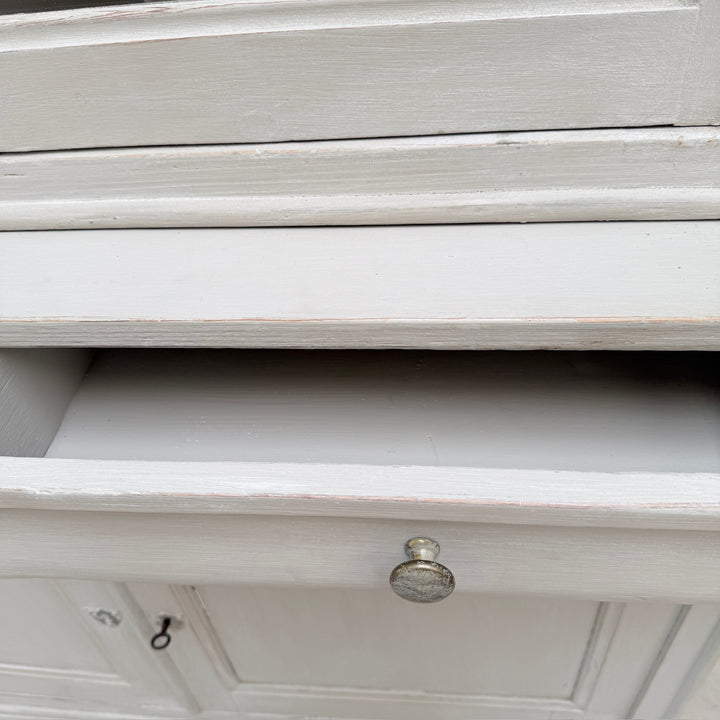 A close up of the inside of a drawer on the antique French painted oak Buffet Deux Corps.
