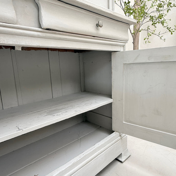 Spacious interior storage inside the antique French painted oak Buffet Deux Corps.
