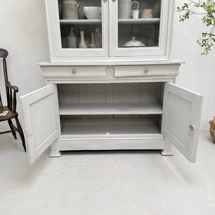Spacious interior storage inside the antique French painted oak Buffet Deux Corps.
