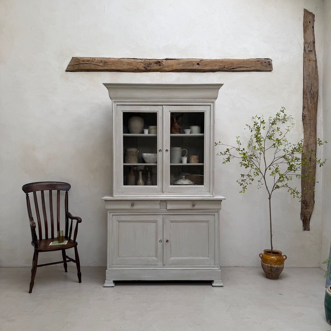 Close-up showing the softly aged painted finish of the antique French oak cabinet.
