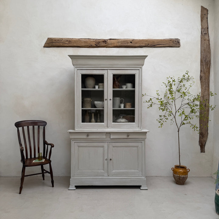 Close-up showing the softly aged painted finish of the antique French oak cabinet.
