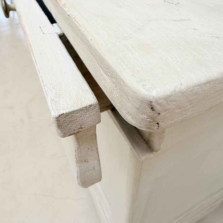 Shelf edge detail showing the authentic wear and patina of the antique French cabinet.
