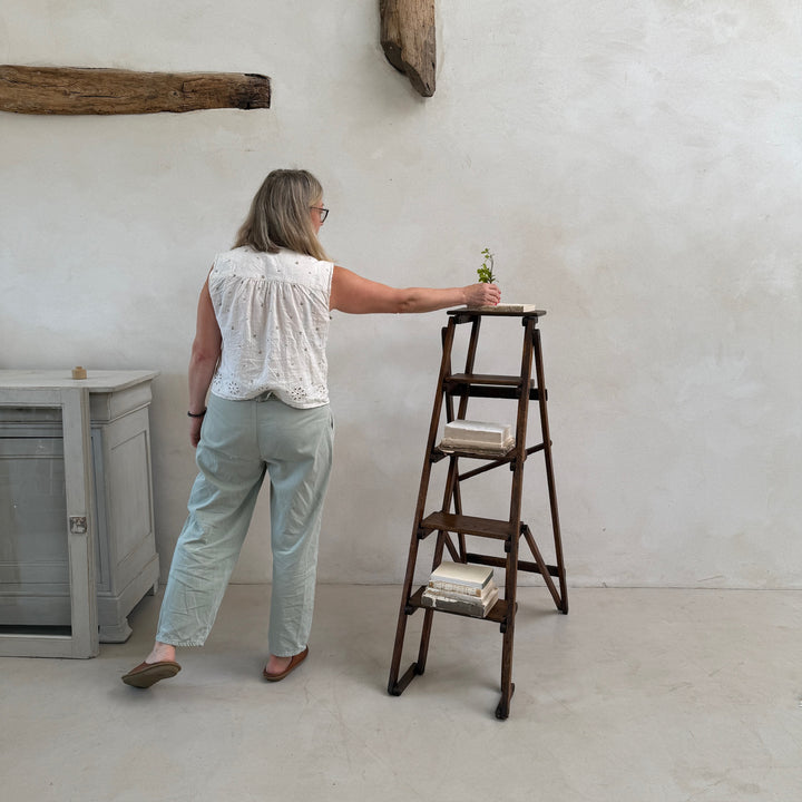 Antique English Library Ladder Margot shown in use to demonstrate its practical height and proportions.
