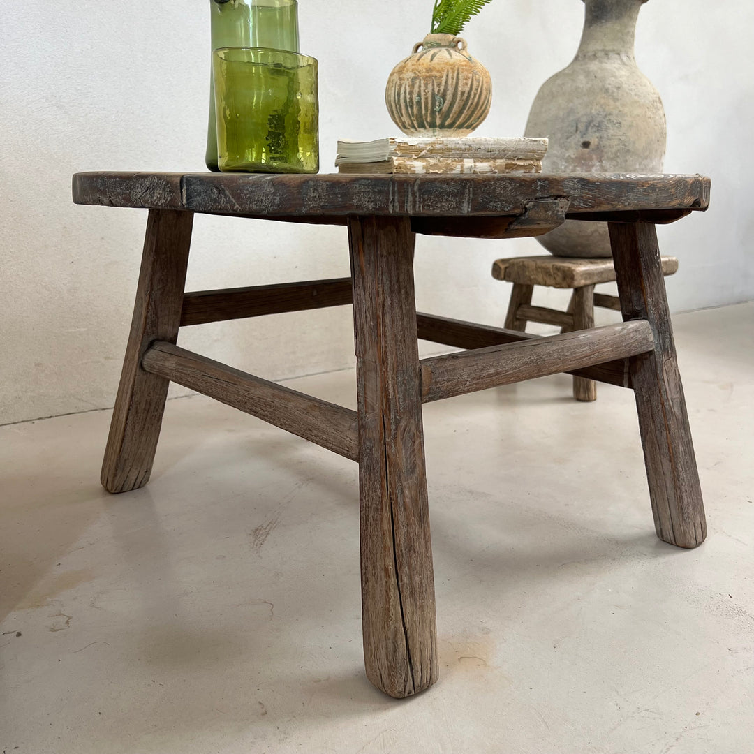 Side view of the Antique Round Elm Side Table Morgana showing its handcrafted solid elm construction and rustic character.
