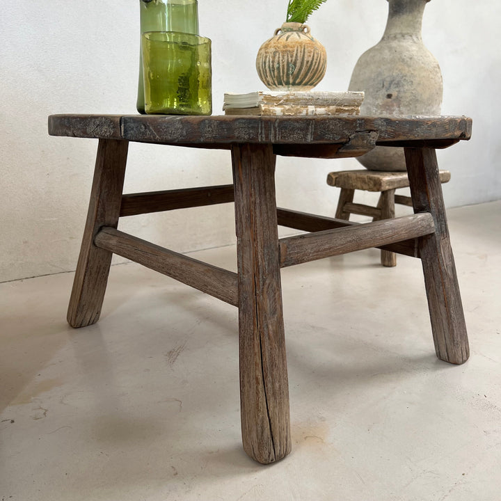 Side view of the Antique Round Elm Side Table Morgana showing its handcrafted solid elm construction and rustic character.
