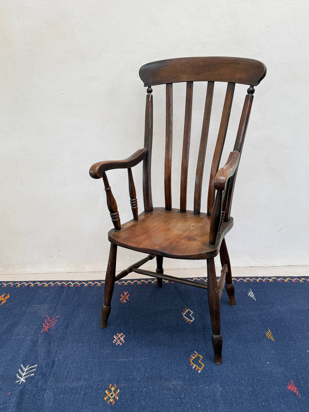 Antique Victorian elm Windsor chair Harry with traditional spindle back, shaped arms and rich aged patina.