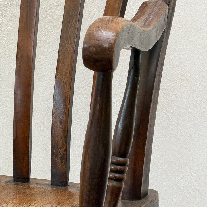 Detail of the hand-shaped armrest and turned supports on the Antique Victorian Elm Windsor Chair Harry.
