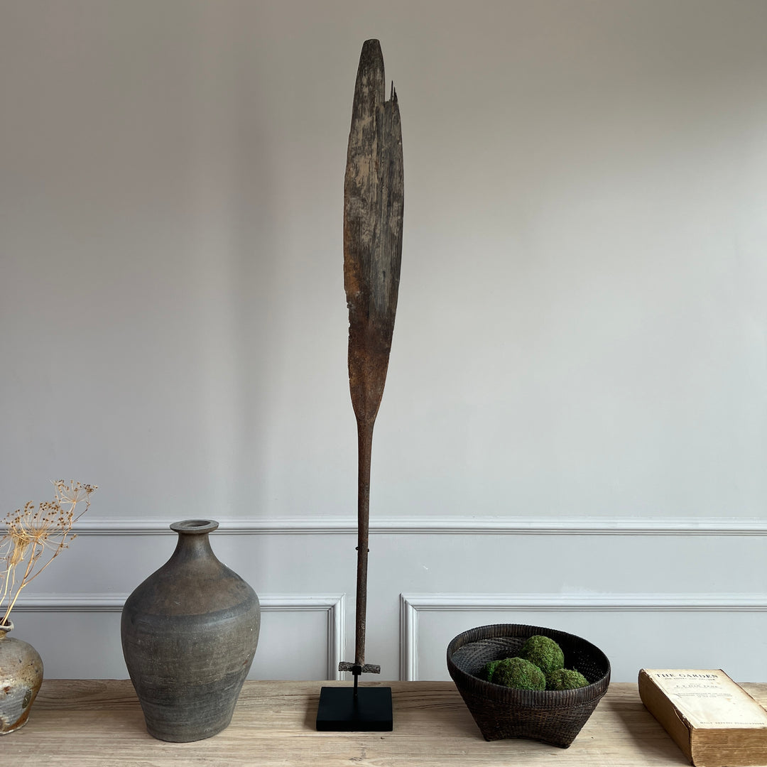 antique wooden paddle on stand