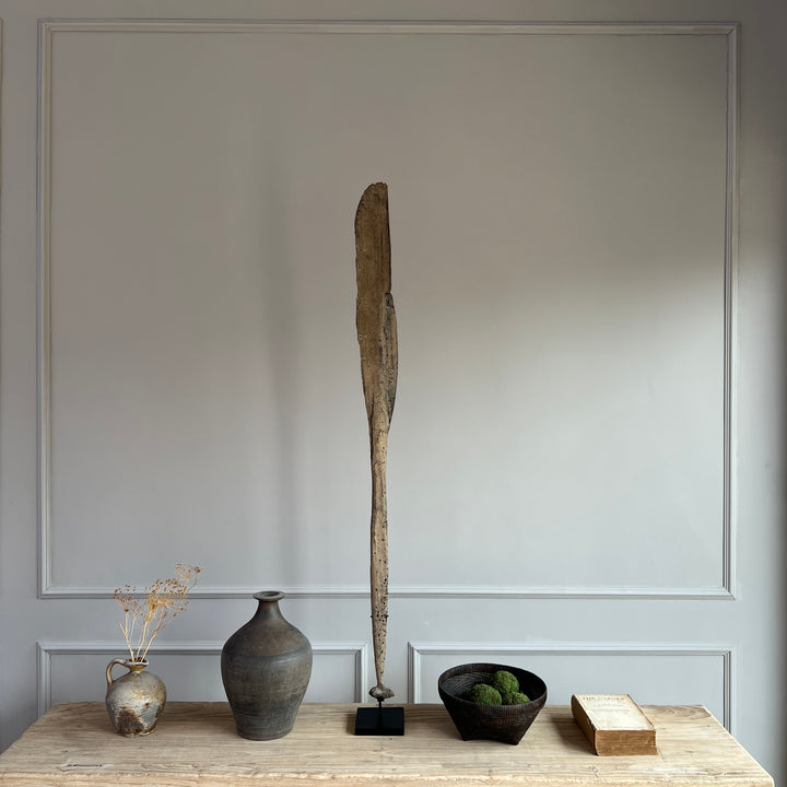 antique wooden paddle on stand