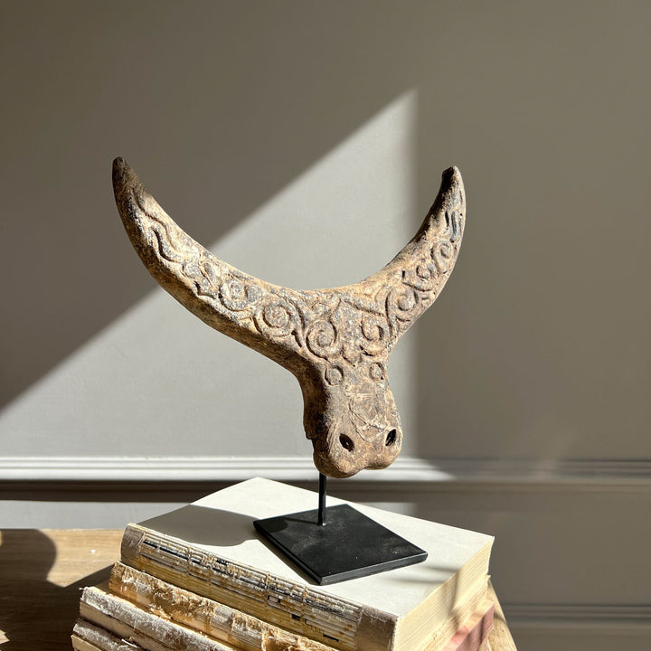 Antique carved horned statue