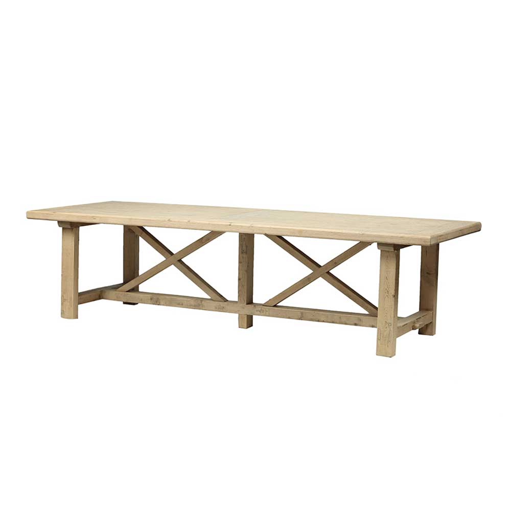 Angled view of the substantial reclaimed pine refectory dining table and architectural cross frame base