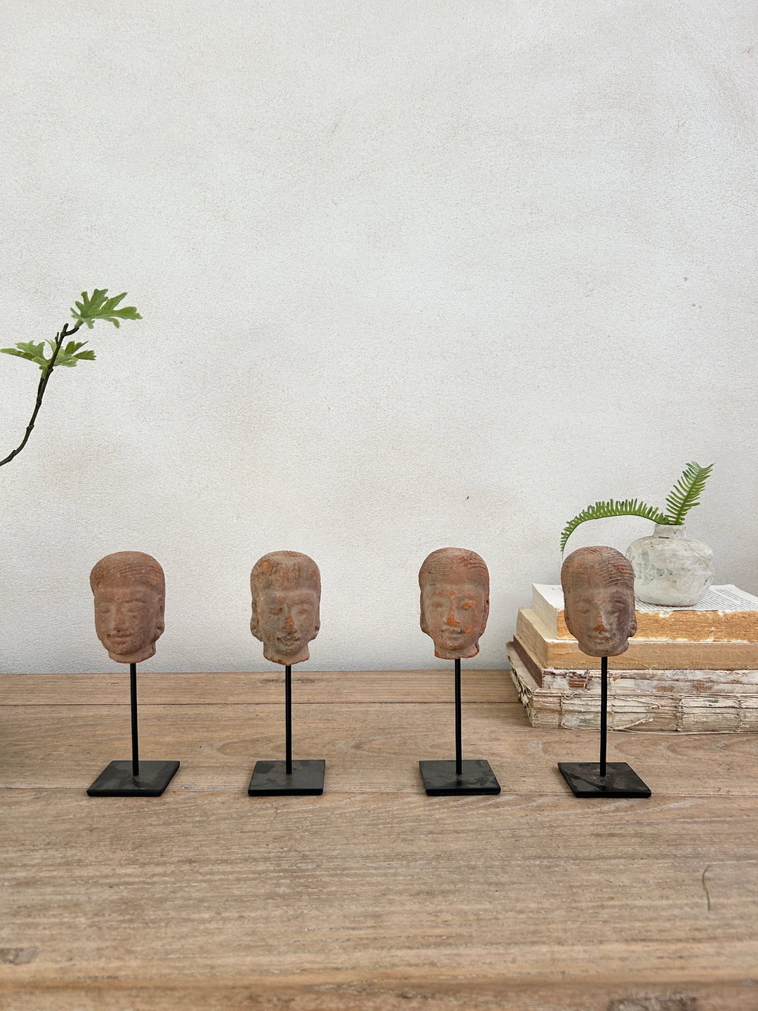 hand-carved antique terracotta heads on stand | Sita