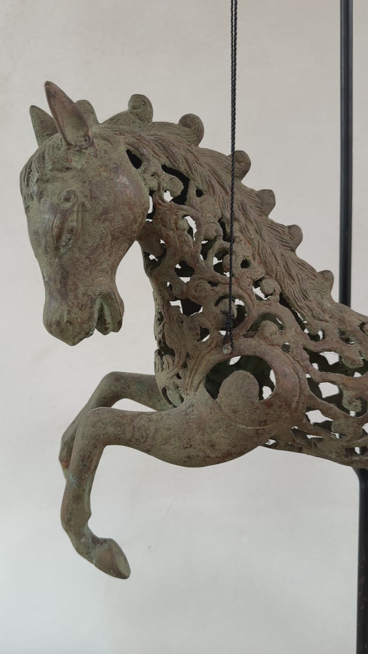 Large suspended bronze horse on stand