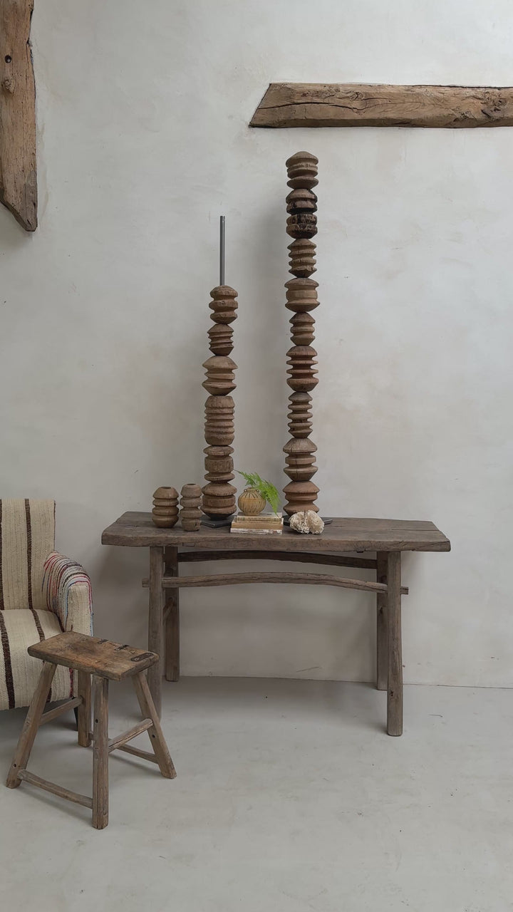 Wooden totem pole of pulleys