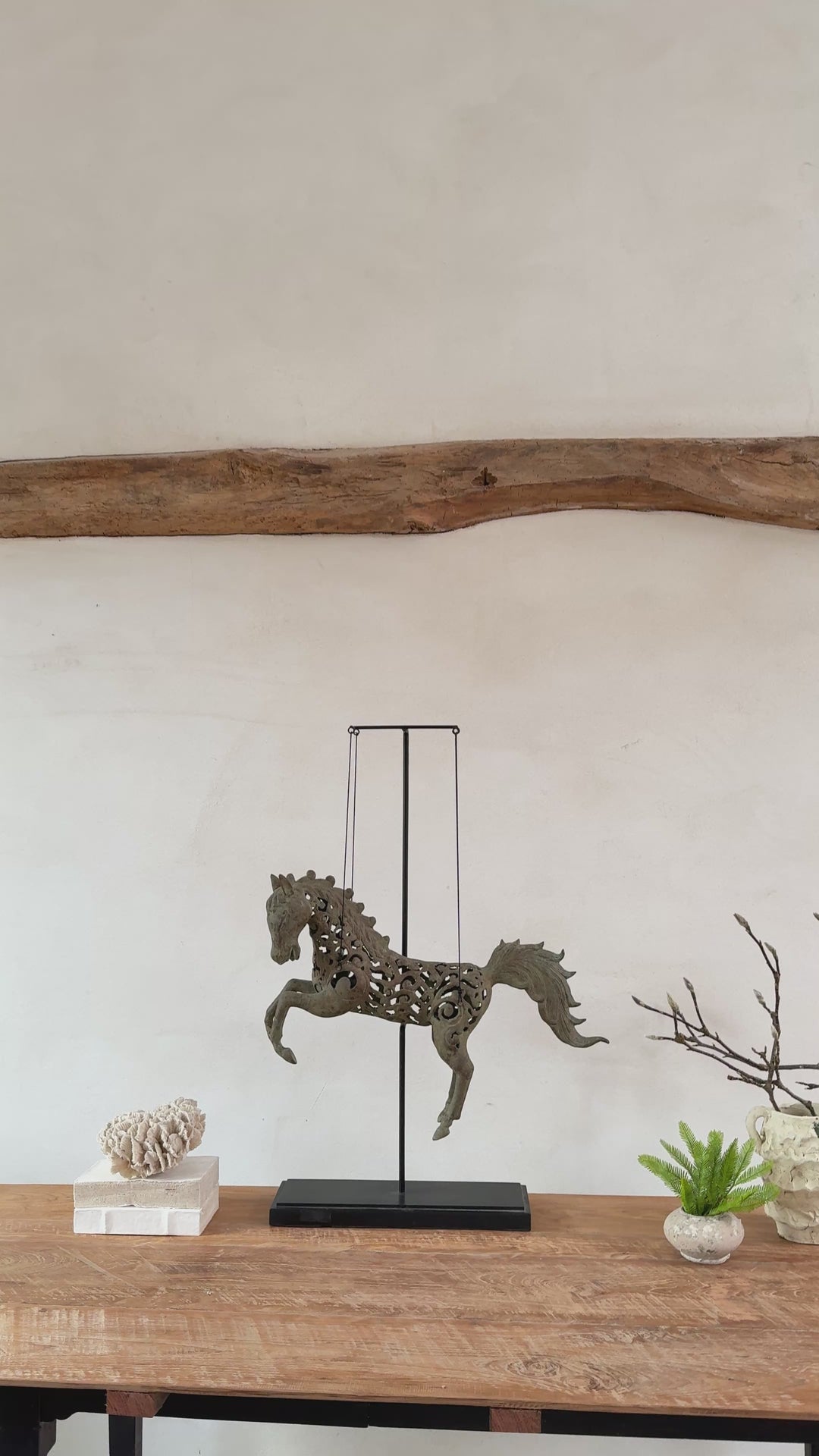 Large suspended bronze horse on stand