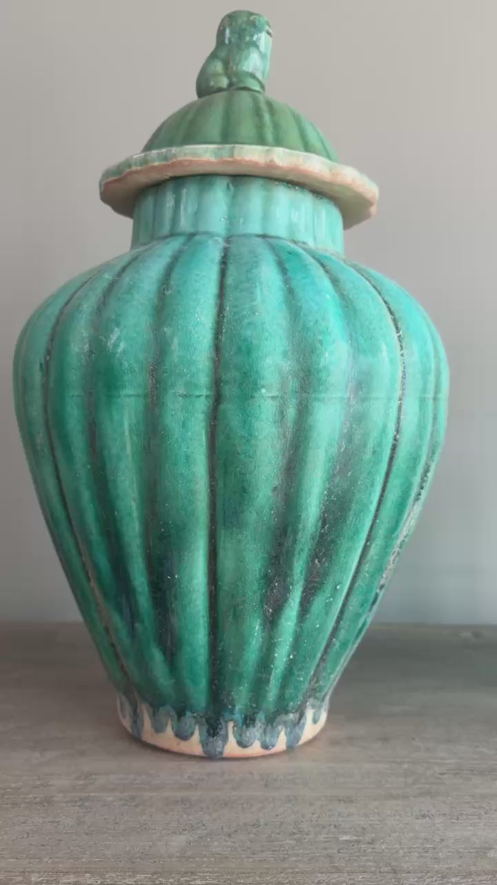 Video of a handcrafted green glazed stoneware temple jar, capturing its elegant proportions and decorative detailing from every angle
