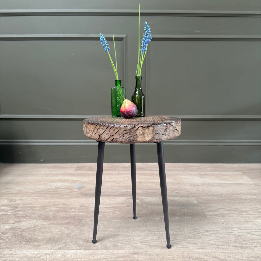 Small rustic elm side table with a solid elm round top and black cast iron hairpin legs.