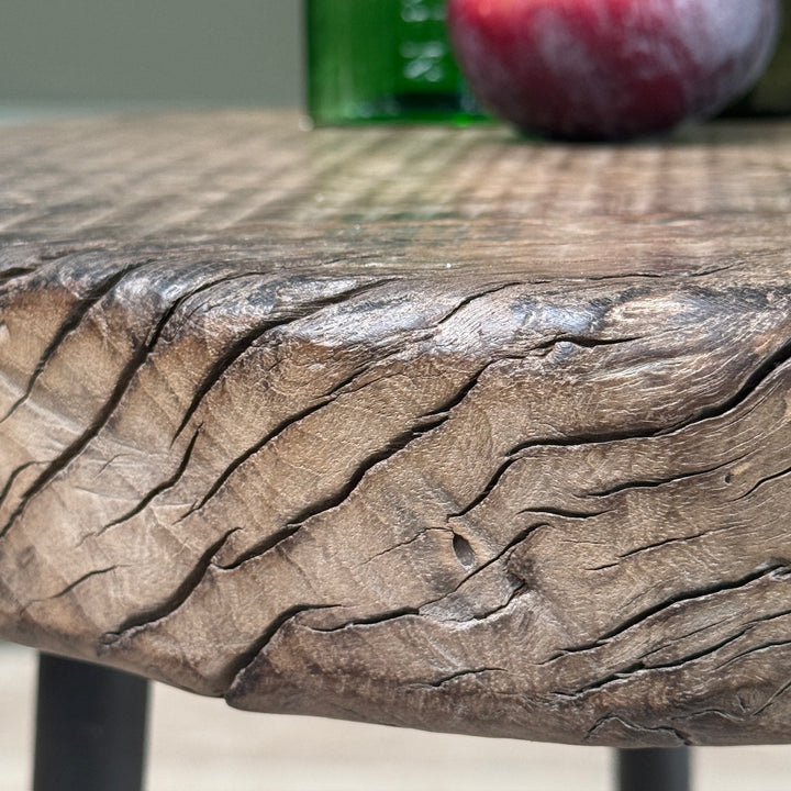 Detailed view of the solid elm edge showing the unique grain, knots and natural character of the Small Rustic Elm Side Table Eva.