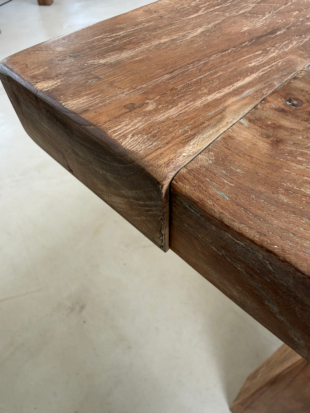 Traditional breadboard ends are designed to allow the solid timber to expand and contract naturally with seasonal changes in humidity, so a slight step where the end meets the tabletop is a normal characteristic of quality solid wood furniture and not a defect.