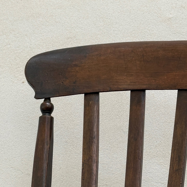Close-up of the curved crest rail and spindle back on the Antique Victorian Elm Windsor Chair Harry.
