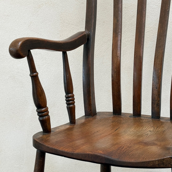 Close-up of the shaped elm seat, turned arm supports and spindle back on the Antique Victorian Windsor chair Harry.
